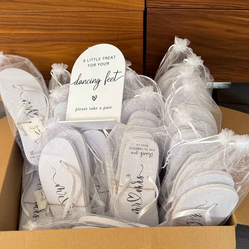 White Flip Flops and sign for Wedding Reception